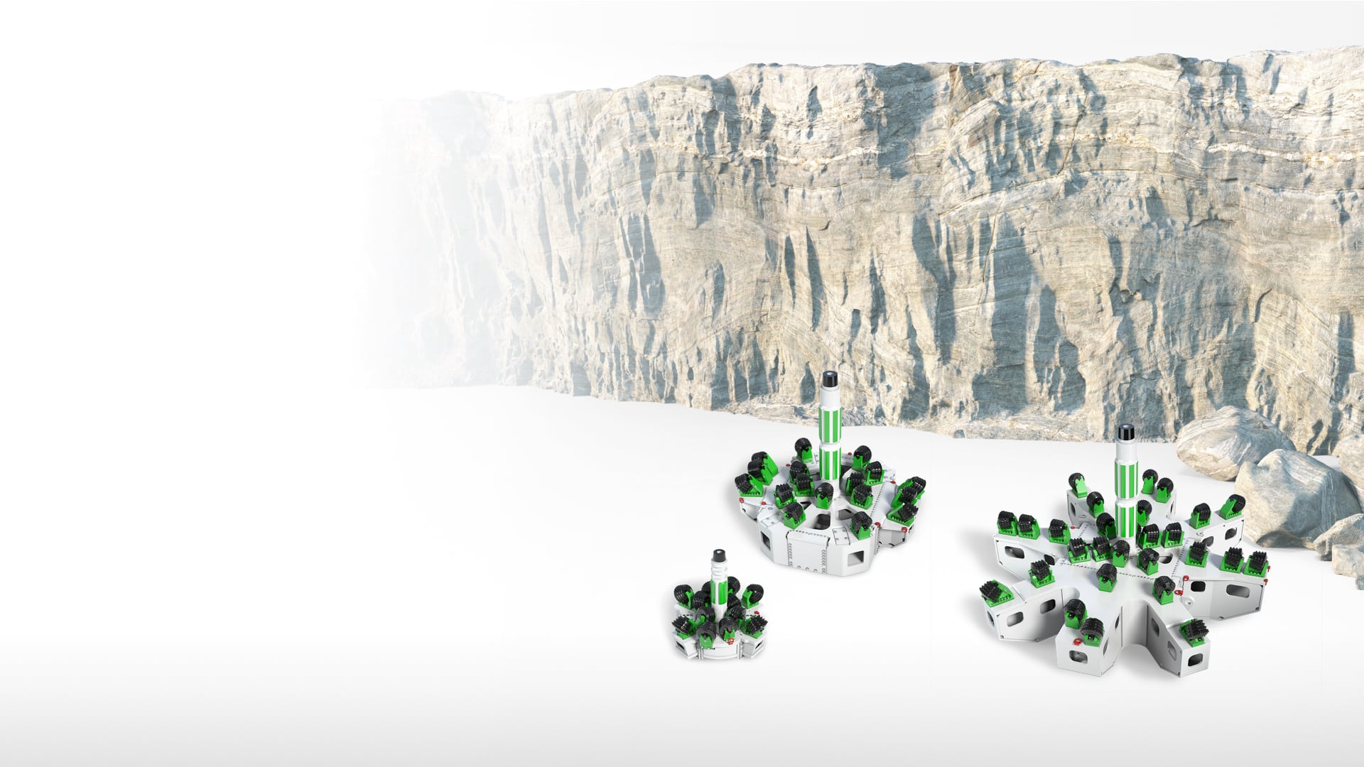 3D illustration of three expansion drill heads in different sizes with a stone wall in the background